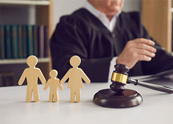 Wooden block family in front of a judge