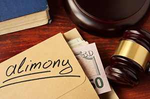 Gavel, cash, and folder labeled alimony on desk