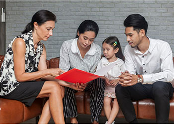 Female attorney sitting with two parents and a child