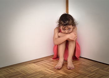 Sad and unhappy young girl sitting on the floor