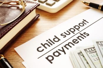 Child support payment document with money resting on top of it