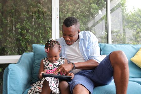 Father spending time with his daughter on a tablet
