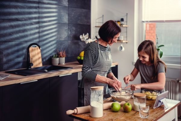 Mother and daughter cooking together happily